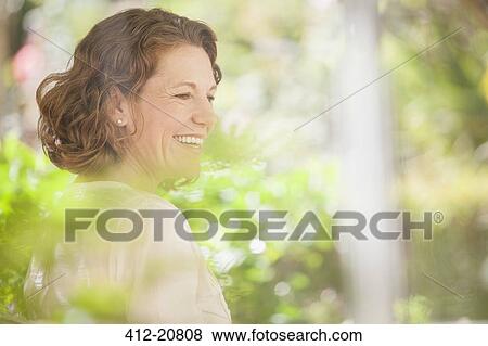Stock Photo - Older woman smiling outdoors . Fotosearch