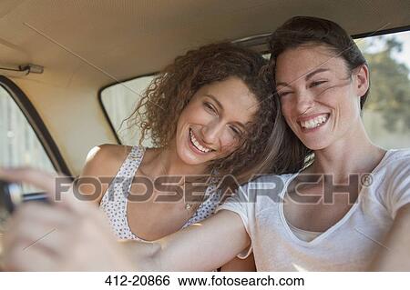 Sisters taking picture together on cell phone View Large Photo Image Stock Photograph - Sisters taking picture together on cell phone . Fotosearch