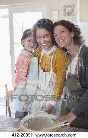 Stock Image - Three generations of women baking together. Fotosearch