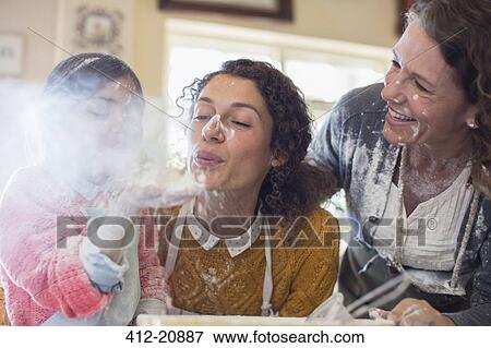 Three generations of women playing with flour View Large Photo Image Stock Photo - Three generations of women playing with flour . Fotosearch
