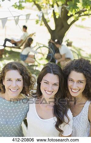 Three women hugging outdoors View Large Photo Image Stock Photograph - Three women hugging outdoors . Fotosearch