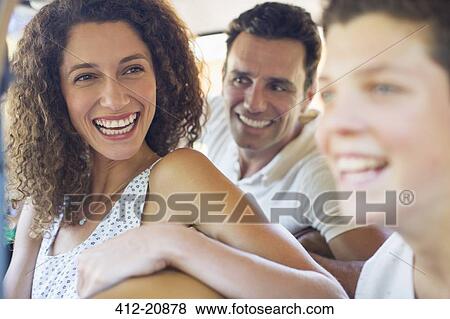 Woman enjoying car ride with family View Large Photo Image Stock Photo - Woman enjoying car ride with family . Fotosearch