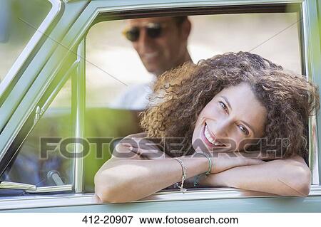 Woman relaxing on car door during car ride View Large Photo Image Stock Photo - Woman relaxing on car door during car ride. Fotosearch