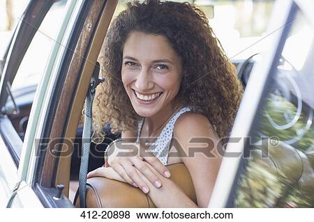 Stock Photo - Woman riding in car on sunny day . Fotosearch