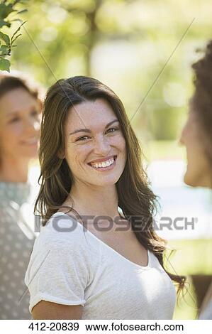 Stock Photo - Woman smiling outdoors. Fotosearch