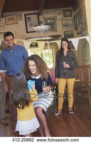 Young girl giving mother gift View Large Photo Image Stock Image - Young girl giving mother gift . Fotosearch