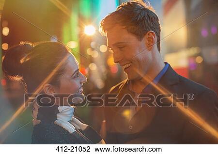 Couple hugging on city street at night View Large Photo Image Stock Image - Couple hugging on city street at night . Fotosearch