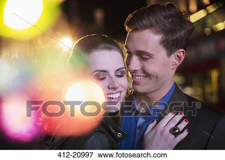 Stock Photo - Couple hugging on city street . Fotosearch