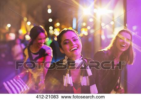 Stock Image - Friends playing on city street at night. Fotosearch
