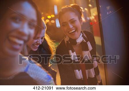 Friends playing on city street at night View Large Photo Image Stock Image - Friends playing on city street at night. Fotosearch
