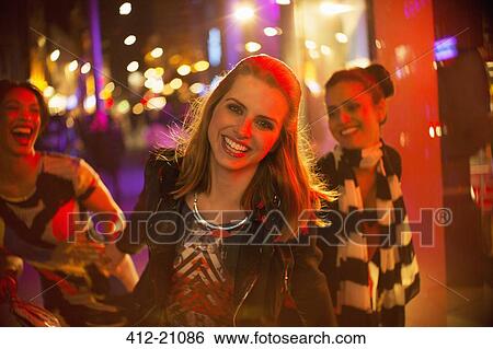 Friends playing on city street at night View Large Photo Image Stock Photograph - Friends playing on city street at night. Fotosearch