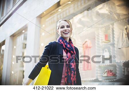 Woman shopping on city street View Large Photo Image Stock Image - Woman shopping on city street . Fotosearch