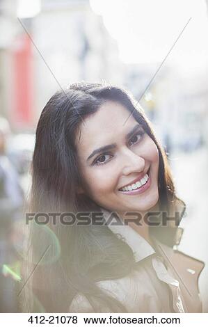 Woman smiling on city street View Large Photo Image Stock Photo - Woman smiling on city street. Fotosearch