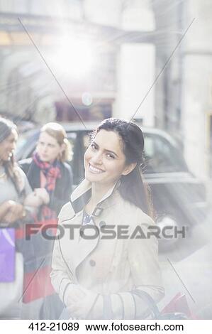 Stock Photo - Woman smiling on city street. Fotosearch