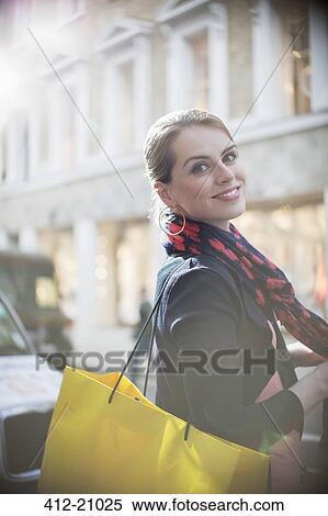 Woman with shopping bag crossing city street View Large Photo Image Stock Photography - Woman with shopping bag crossing city street . Fotosearch