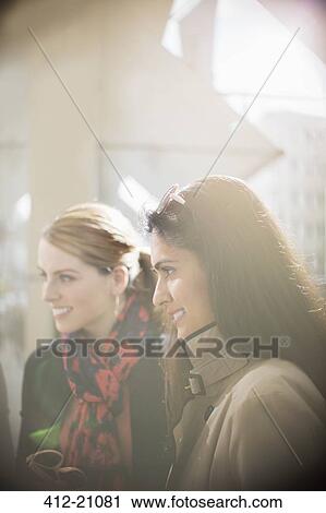 Women smiling on city street View Large Photo Image Stock Image - Women smiling on city street . Fotosearch