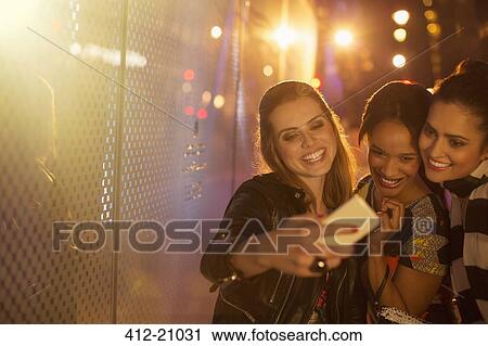 Women taking cell phone picture together View Large Photo Image Stock Image - Women taking cell phone picture together. Fotosearch