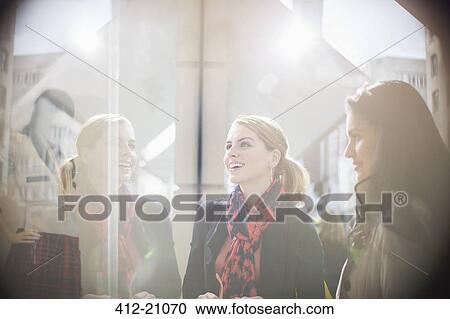 Women talking on city street View Large Photo Image Stock Image - Women talking on city street. Fotosearch