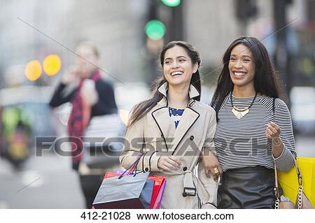 Stock Photo - Women walking together down city street. Fotosearch