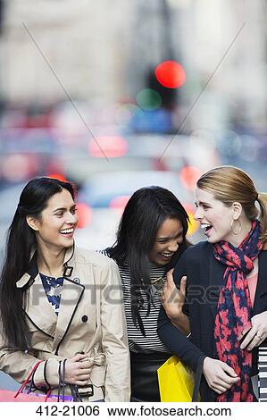 Stock Photograph - Women walking together down city street. Fotosearch