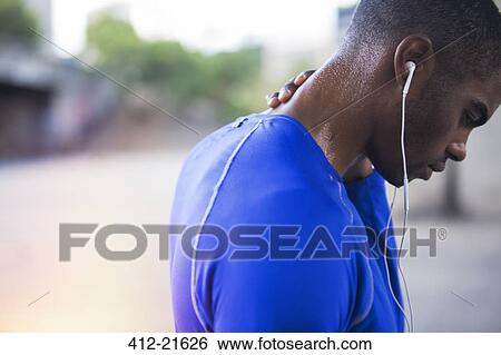 Man resting after exercising on city street View Large Photo Image Stock Photograph - Man resting after exercising on city street. Fotosearch