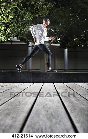 Man running through city streets View Large Photo Image Picture - Man running through city streets. Fotosearch