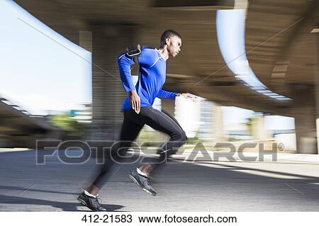 Man running through city streets View Large Photo Image Stock Image - Man running through city streets. Fotosearch