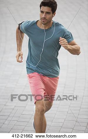 Man running through city streets View Large Photo Image Stock Image - Man running through city streets. Fotosearch
