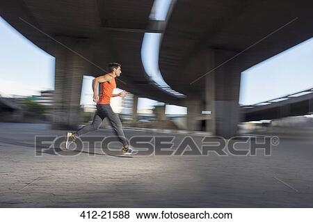 Stock Photo - Man running through city streets. Fotosearch