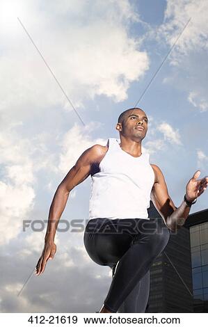 Stock Photo - Man running through city streets. Fotosearch