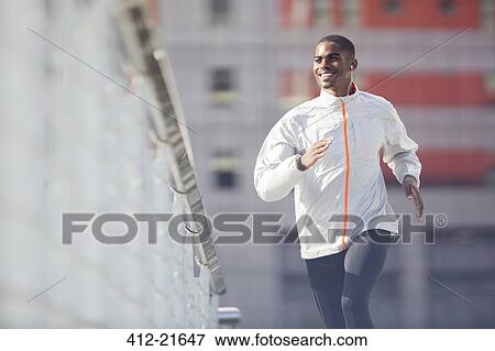 Stock Photo - Man running through city streets . Fotosearch