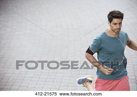 Stock Photography - Man running through city streets. Fotosearch