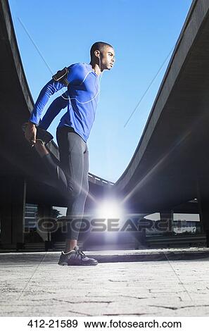 Man stretching before exercising View Large Photo Image Stock Photo - Man stretching before exercising. Fotosearch