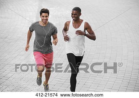 Picture - Men running through city streets together. Fotosearch