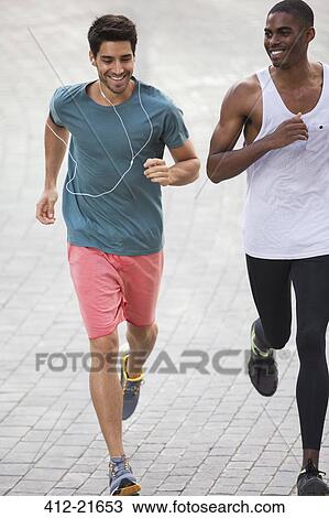 Men running through city streets together View Large Photo Image Stock Image - Men running through city streets together. Fotosearch