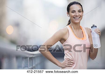 Woman drinking water outdoors View Large Photo Image Stock Photo - Woman drinking water outdoors . Fotosearch