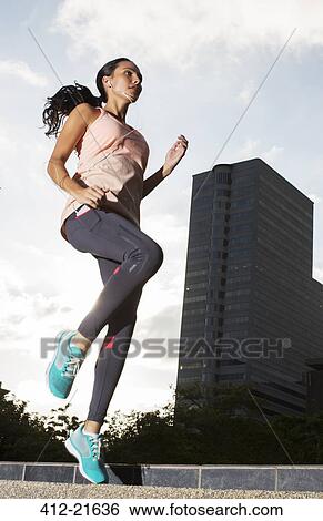 Woman exercising on city streets View Large Photo Image Stock Photograph - Woman exercising on city streets. Fotosearch
