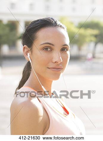 Stock Image - Woman listening to music before exercising. Fotosearch