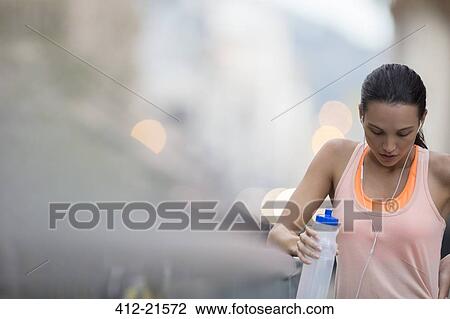 Stock Image - Woman resting after exercise. Fotosearch