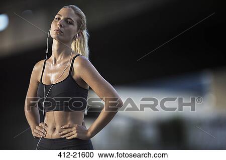 Stock Image - Woman resting after exercising on city street. Fotosearch