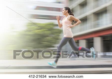 Woman running through city streets View Large Photo Image Picture - Woman running through city streets. Fotosearch