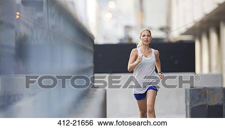 Stock Photograph - Woman running through city streets . Fotosearch