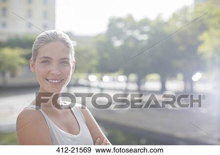 Stock Photo - Woman smiling on city streets. Fotosearch