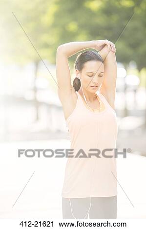 Woman stretching before exercising View Large Photo Image Stock Image - Woman stretching before exercising. Fotosearch