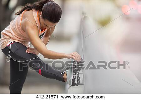 Woman stretching her leg before exercise View Large Photo Image Stock Image - Woman stretching her leg before exercise. Fotosearch