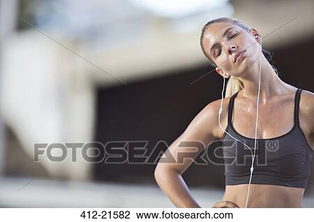 Woman stretching with eyes closed after exercise View Large Photo Image Stock Image - Woman stretching with eyes closed after exercise. Fotosearch
