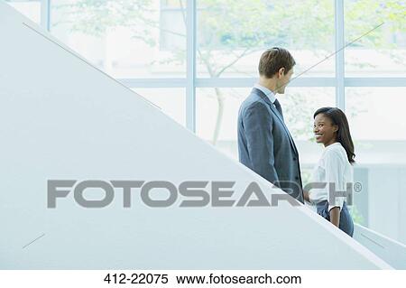 Business people crossing paths on staircase View Large Photo Image Stock Photography - Business people crossing paths on staircase. Fotosearch