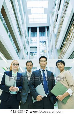 Business people gathered in office building View Large Photo Image Stock Photo - Business people gathered in office building. Fotosearch