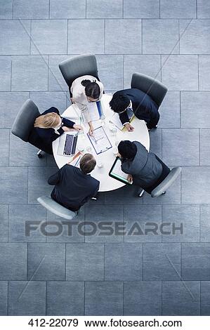 Stock Photo - Business people having meeting at table. Fotosearch
