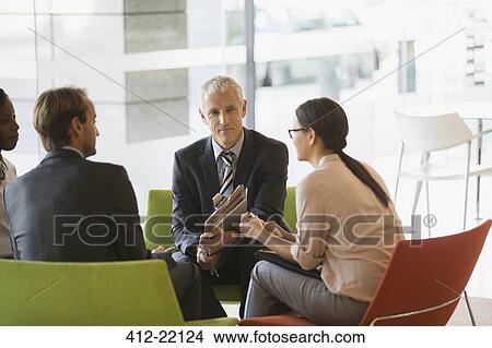 Picture - Business people having meeting in office building. Fotosearch